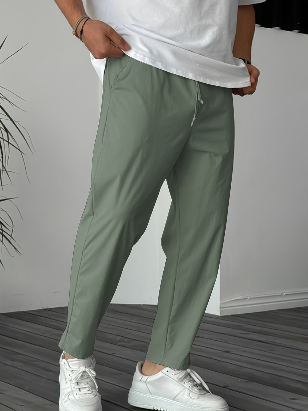 Men's lightweight breathable outdoor pants in neutral tone with elastic waistband and drawstring for hiking