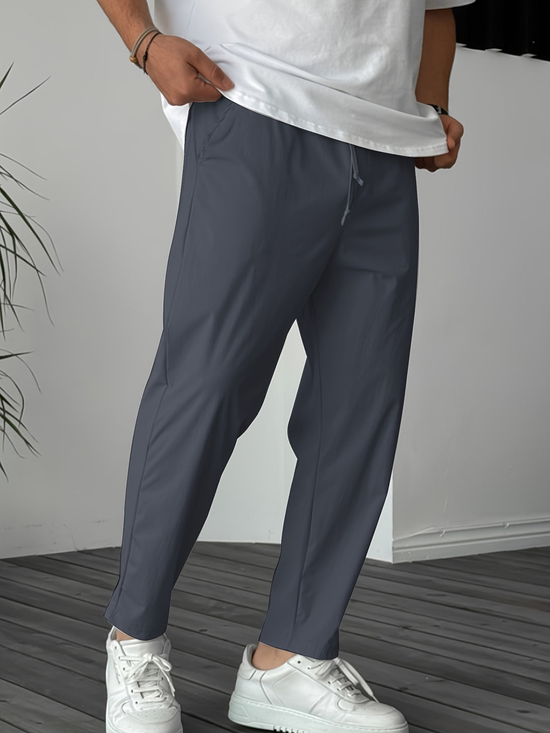 Men's lightweight breathable outdoor pants in neutral tone with elastic waistband and drawstring for hiking