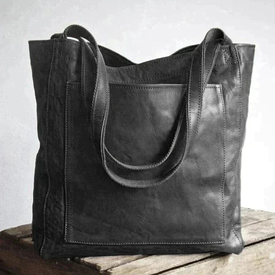Women's tan faux leather tote bag classic silhouette exterior slip pocket snap closure dual handles