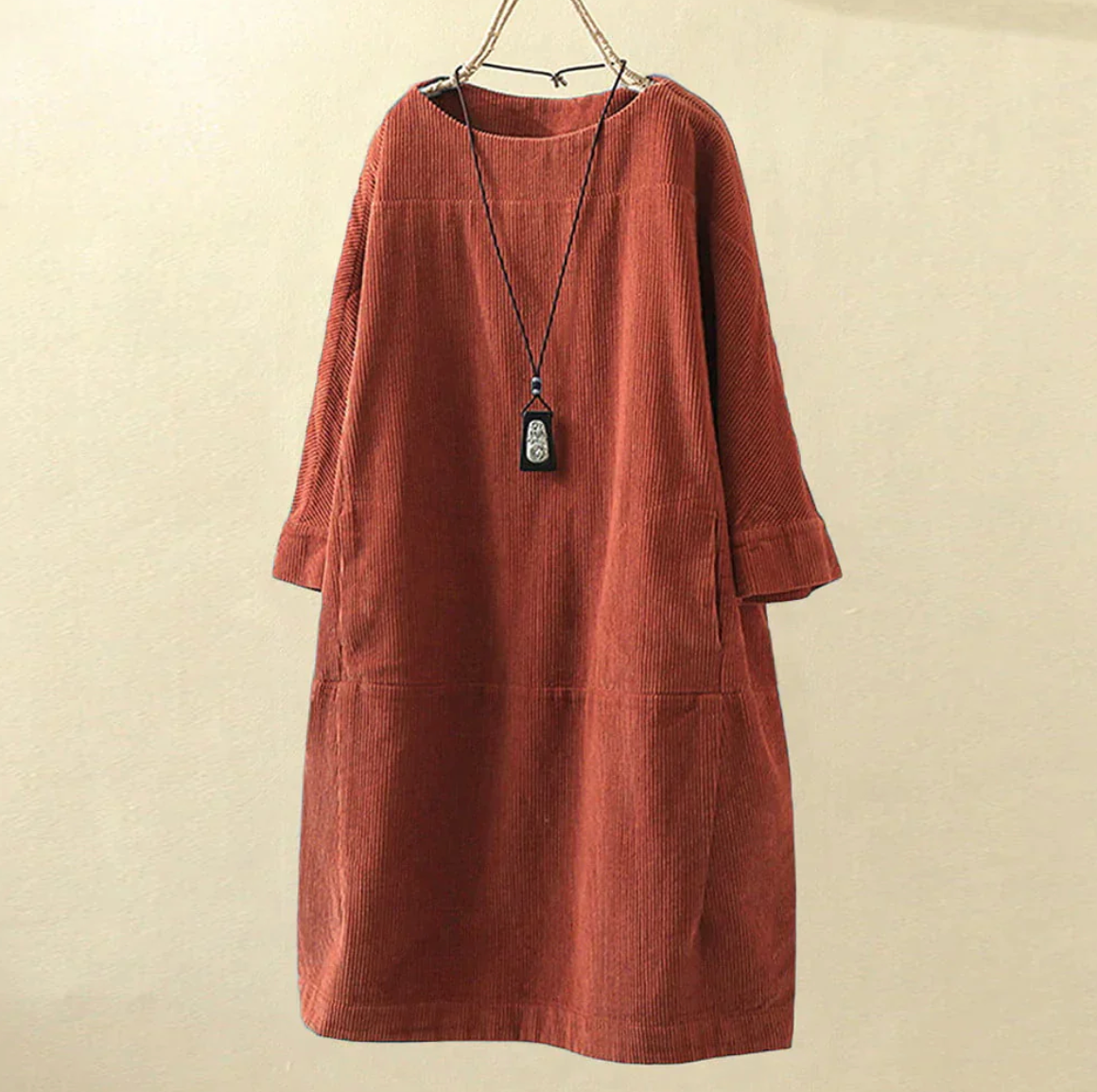 Women's brown corduroy midi dress with textured ribbed fabric, relaxed silhouette, versatile daywear style