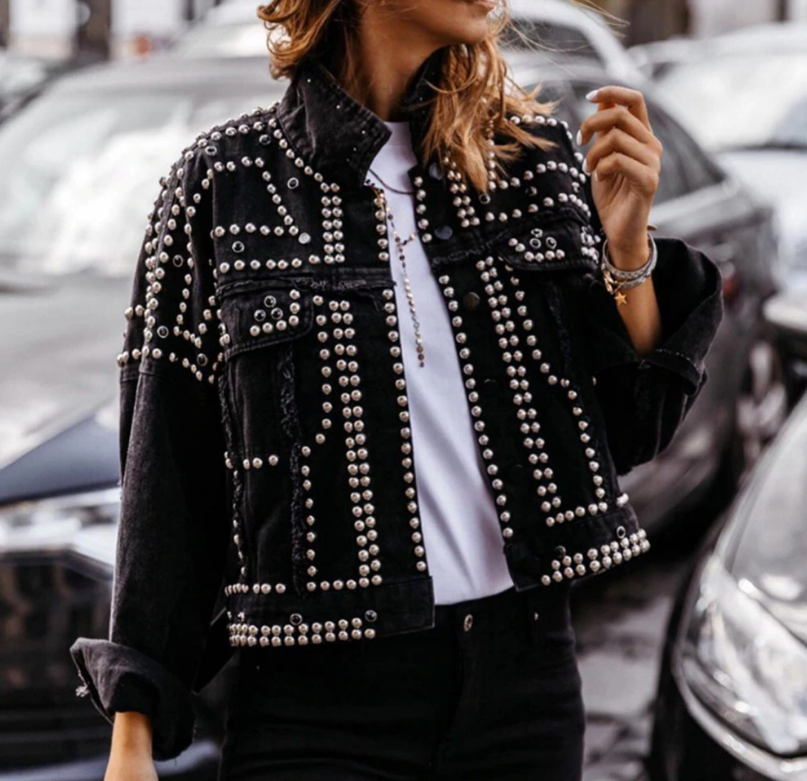 Women's black cropped studded jacket with allover silver studs and raw-edge seams for edgy style
