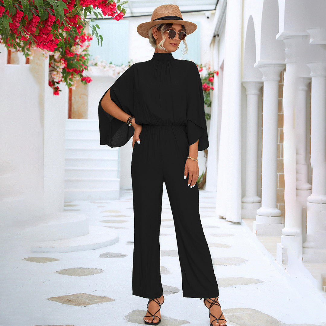 Women's black wide-leg jumpsuit high neck cape sleeves fitted waist Nordic-inspired elegant silhouette
