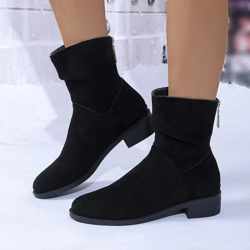 Black women's ankle boots with chic mid heel, pointed toe, and convenient back zipper closure