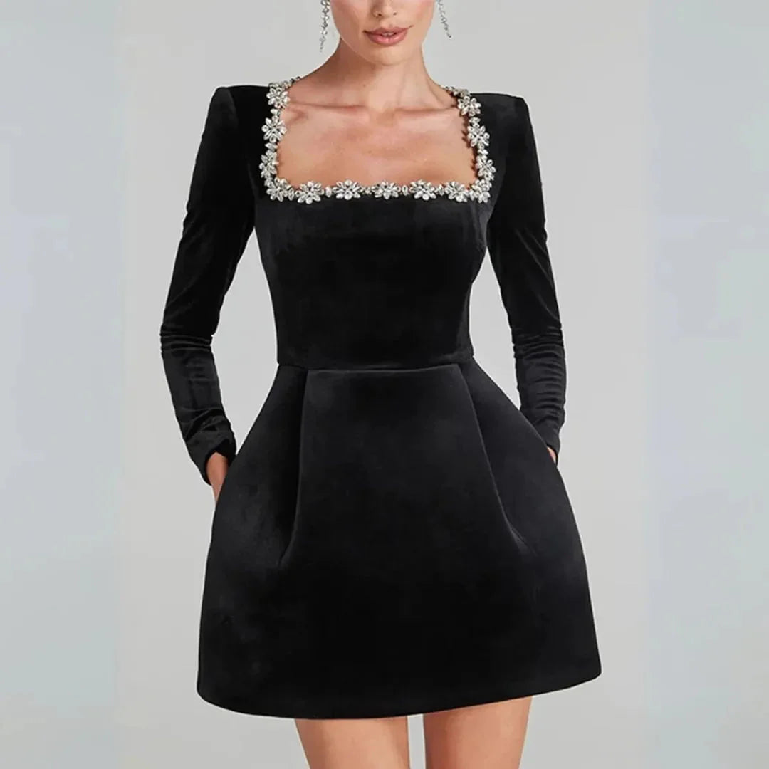 Black velvet square neck mini dress with crystal floral embellishments, sleek modern silhouette