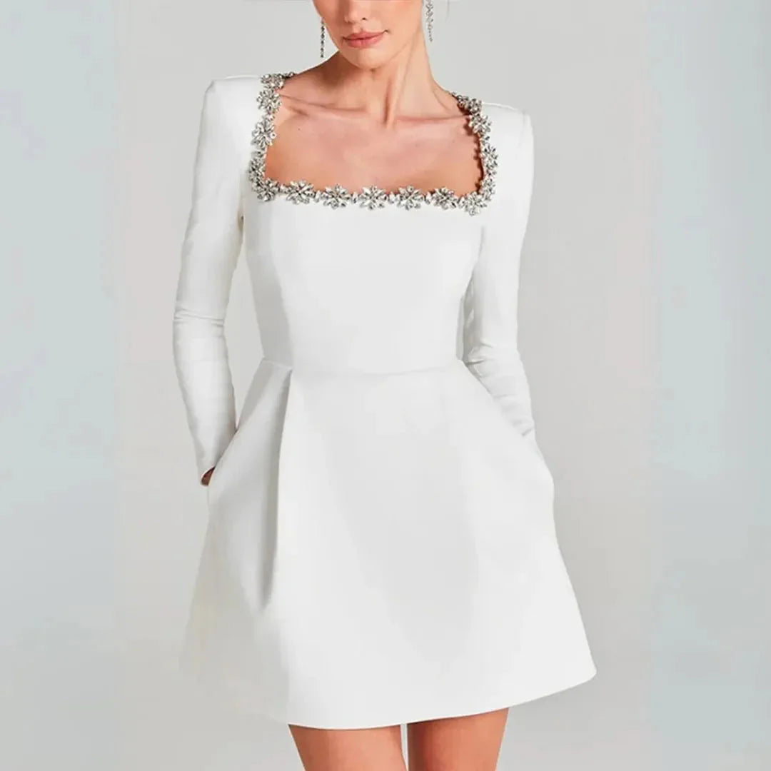 Black velvet square neck mini dress with crystal floral embellishments, sleek cocktail silhouette