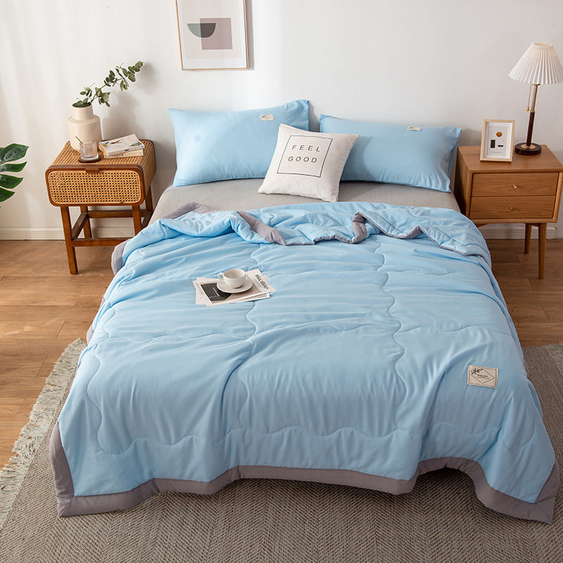Minimalist white cotton quilt with stitched geometric pattern, lightweight breathable design for hot sleepers