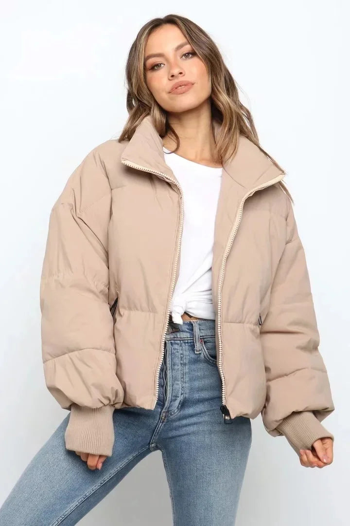 Women's quilted puffer jacket in neutral tone, relaxed fit with high neckline for wind protection
