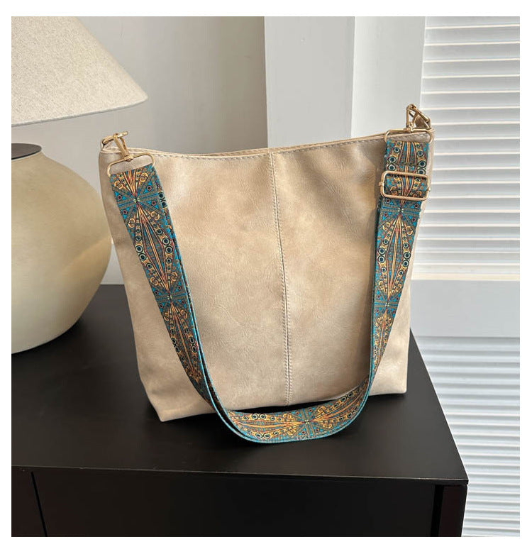 Tall vegan leather bucket bag with embroidered strap, structured silhouette, roomy interior, eco chic style