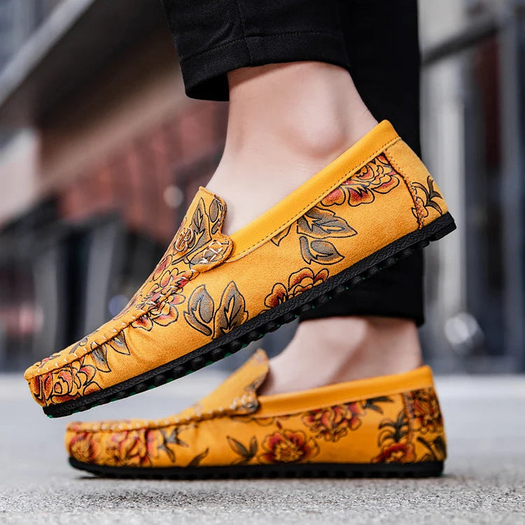 Brown leather loafers with embossed floral detailing, flexible rubber outsole, professional slip-on style