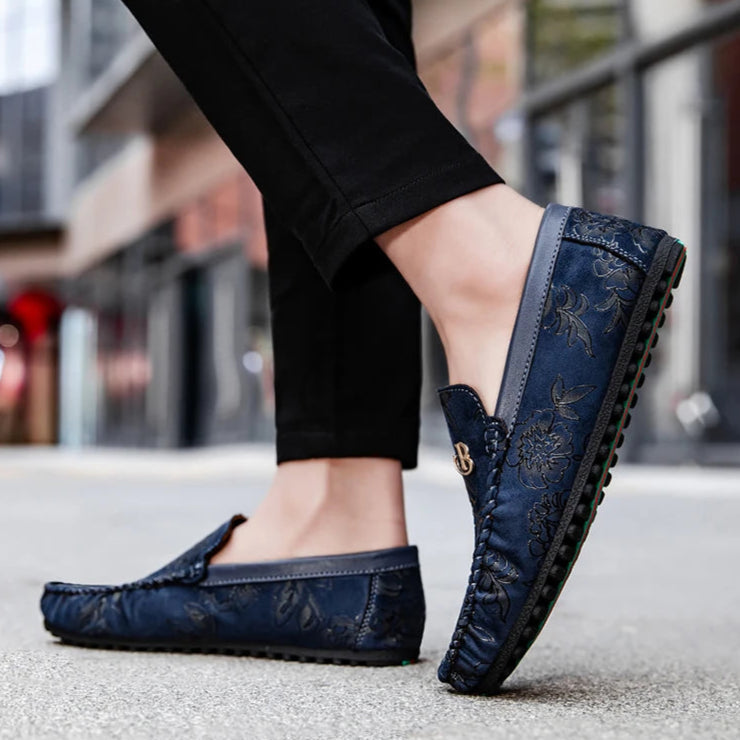 Brown leather loafers with embossed floral detailing, breathable lining, flexible rubber outsole