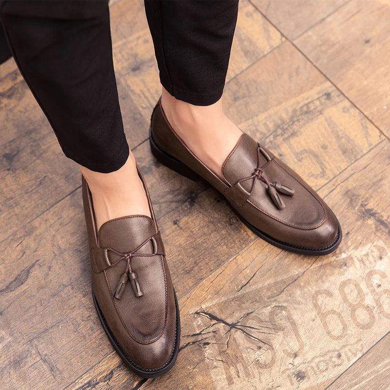 Black genuine leather tassel loafers with cushioned insole and soft lining for professionals