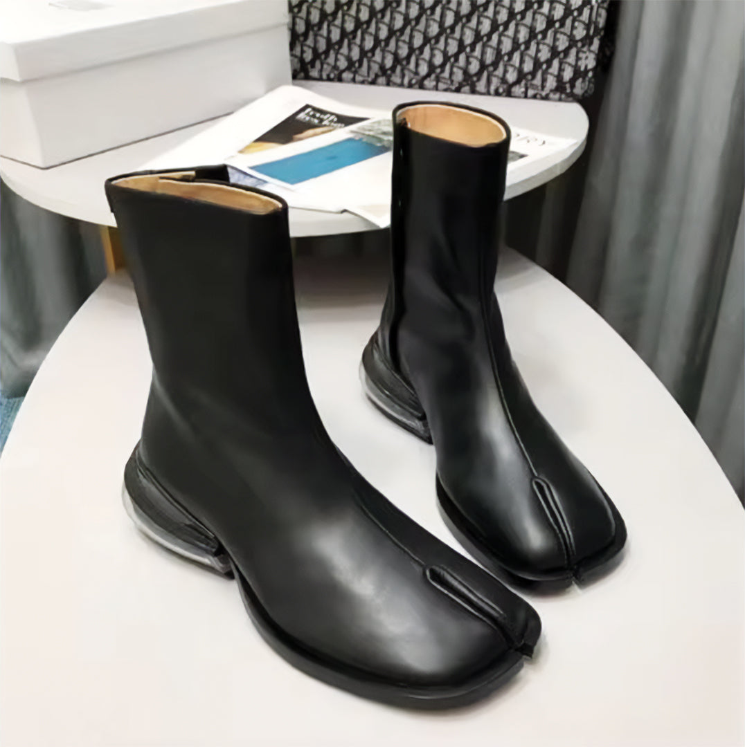 Black leather split-toe tabi boot with air-cushioned heel, bold urban fashion-forward silhouette
