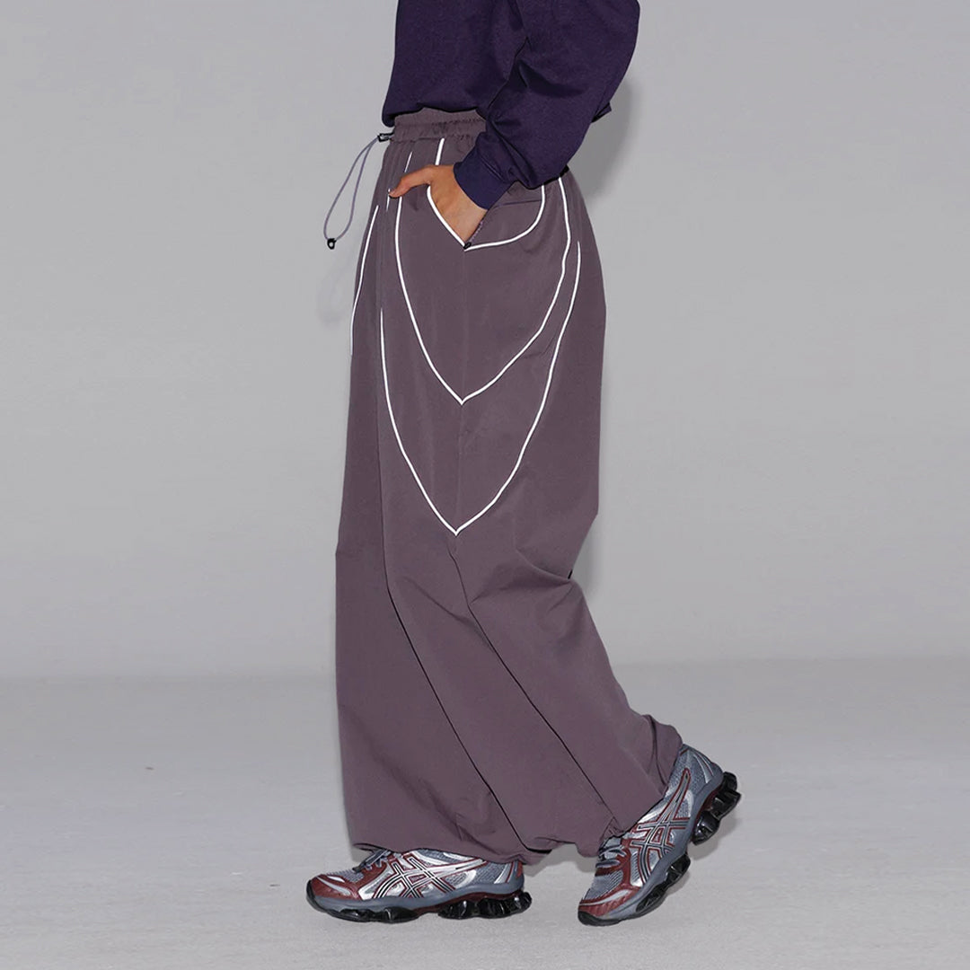 Black wide-leg reflective trousers water-resistant nylon urban outdoor performance pants with stripe detail