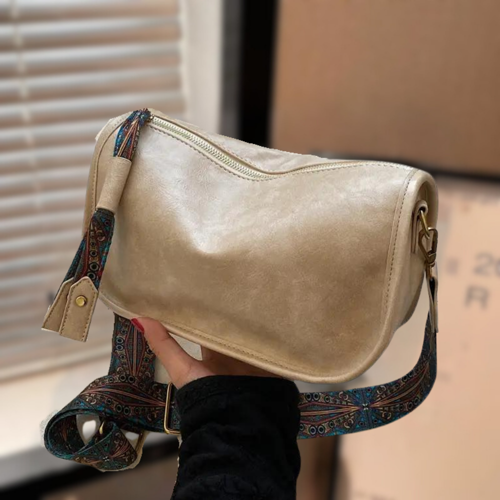 Black leather crossbody bag for women with sleek design, cowhide lining, and durable zipper closure