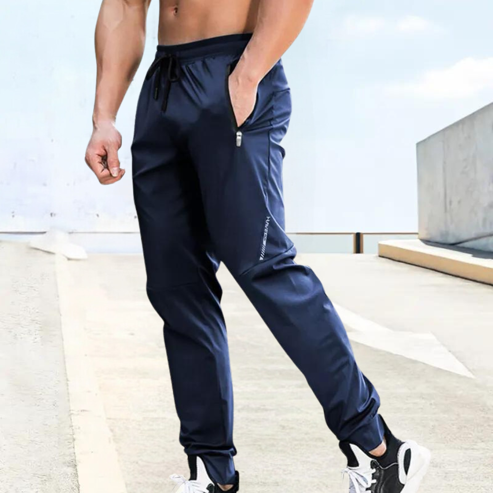 Men's slim fit gray jogger pants with elastic drawstring waist and secure zipper pockets