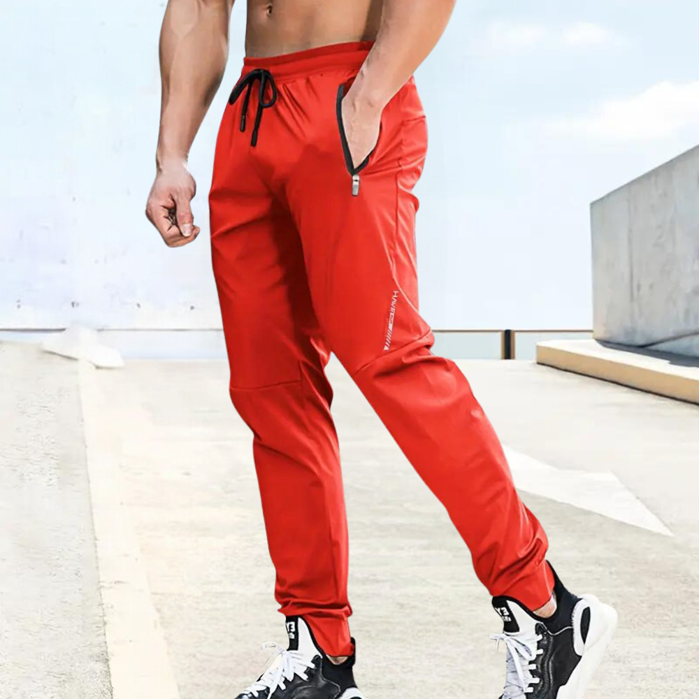 Men's slim fit gray jogger pants with elastic drawstring waist and secure zipper pockets