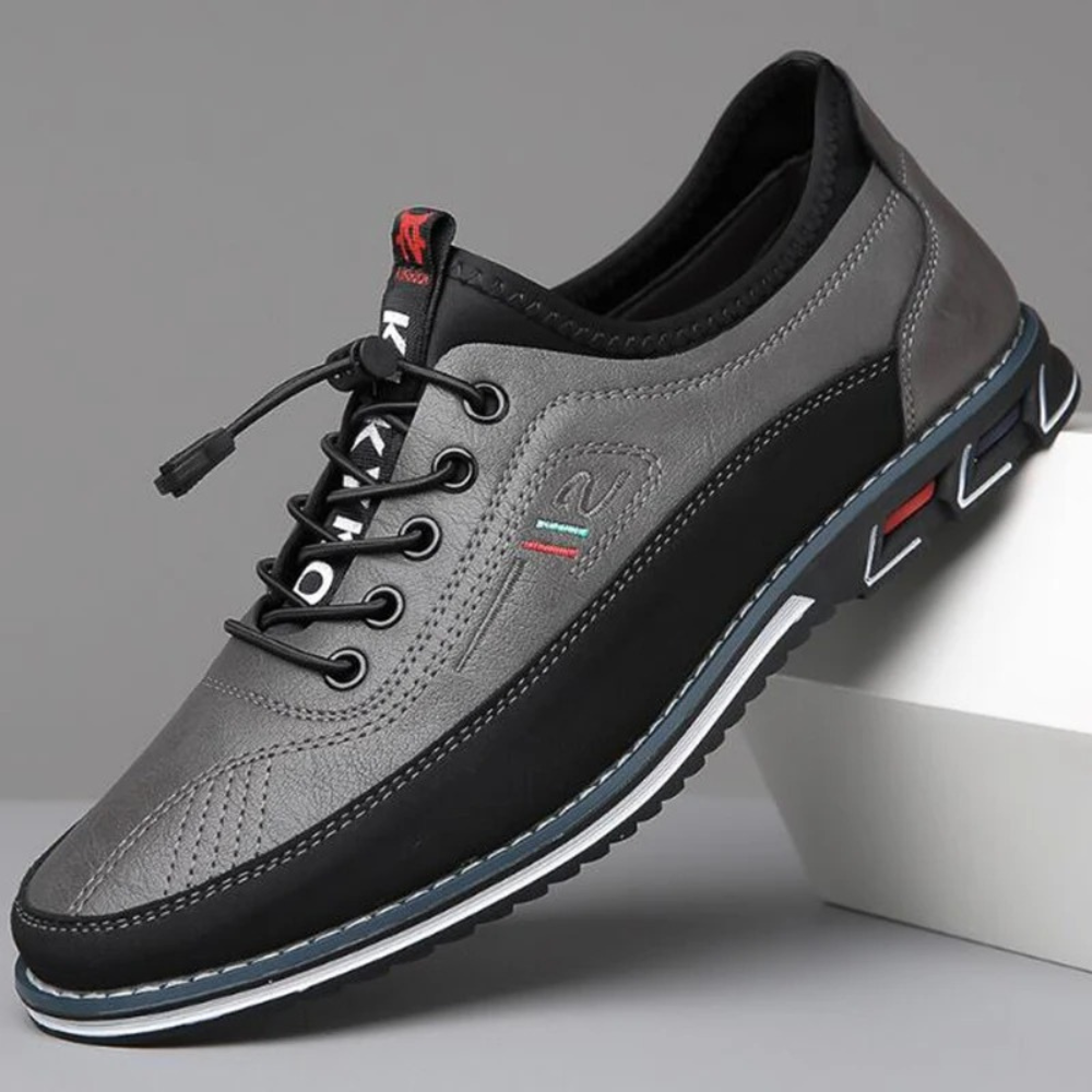 Men's low-profile white leather sneakers with sleek silhouette and shock-absorbing sole