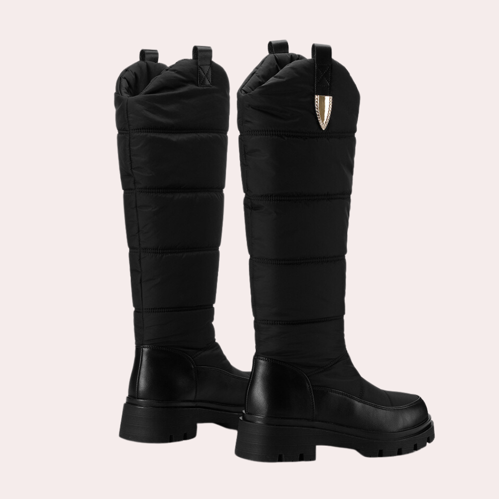 Women's knee-high PU leather boots with quilted shaft and rugged sole in sleek black finish