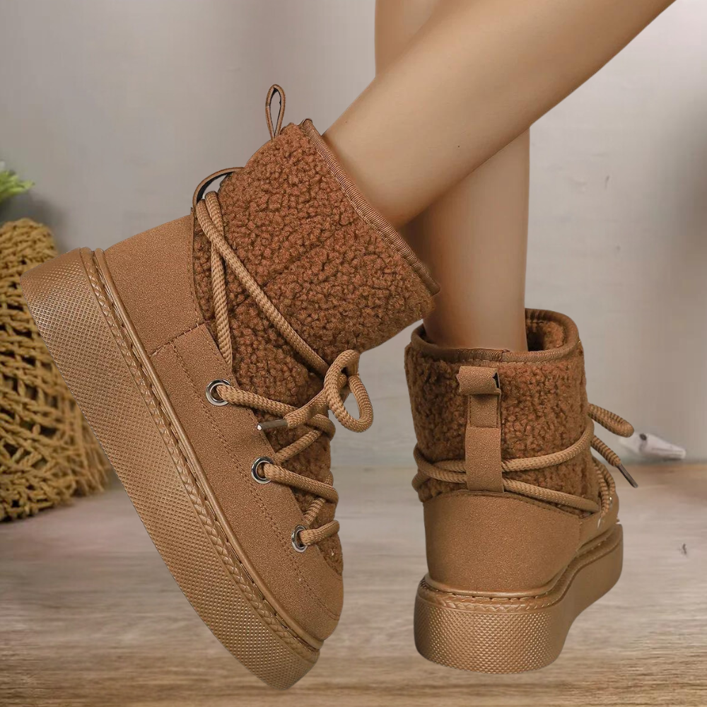 Women's insulated snow boots in neutral tones, featuring a cozy ankle-high silhouette with all-weather grip sole
