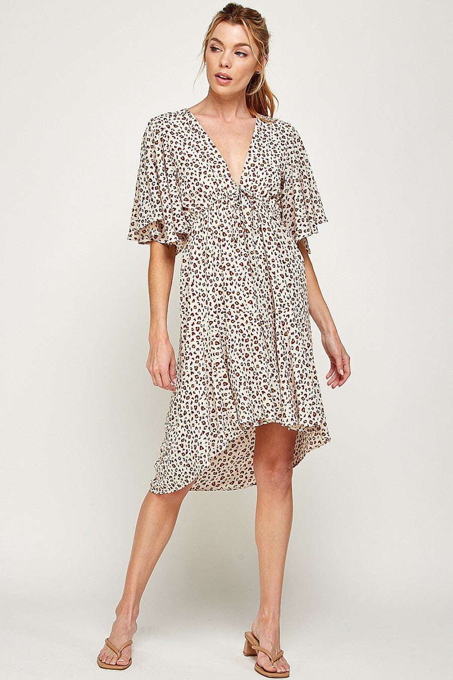 Women's leopard print mini dress with bold high-low hem, fierce chic style for night out