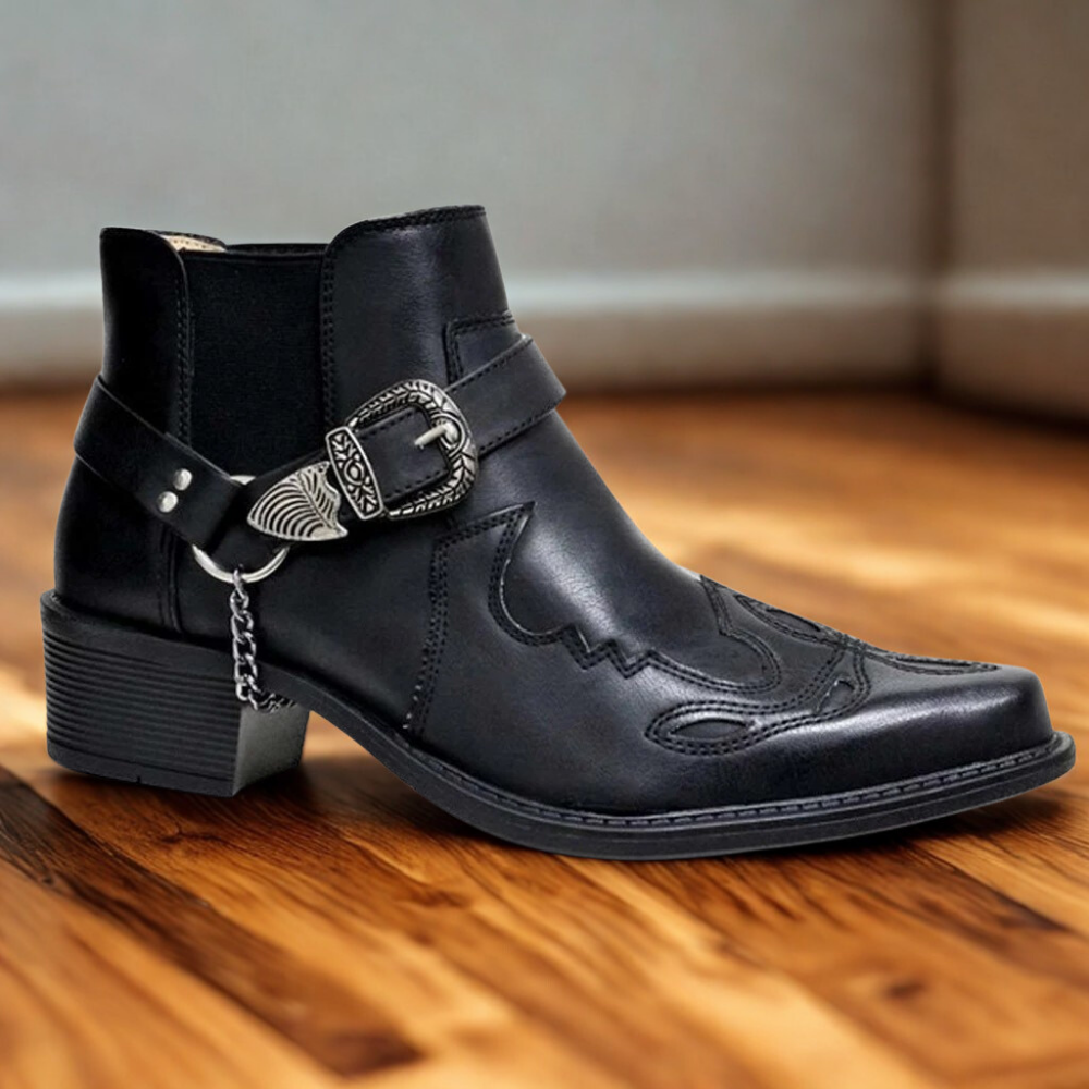 Men's brown faux leather ankle boot with pointed toe, block heel, and buckle chain detail
