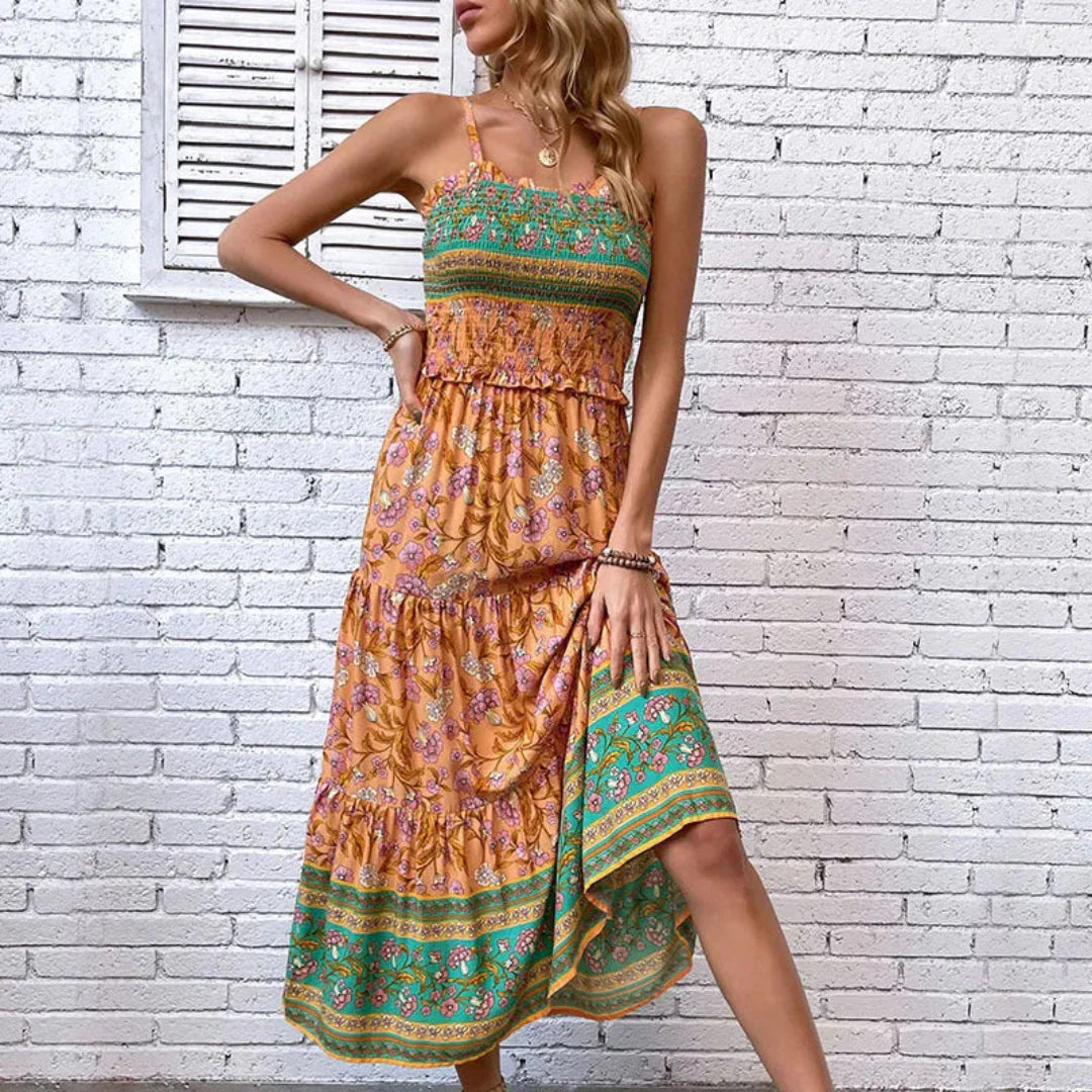 Floral tiered maxi sundress with smocked bodice, adjustable straps, and vibrant green hem