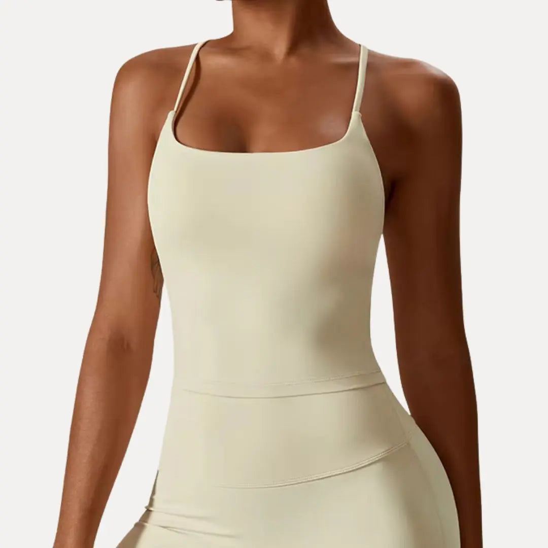 Women's sleek-fit black cross-back tank top with breathable stretch fabric and delicate strap detail