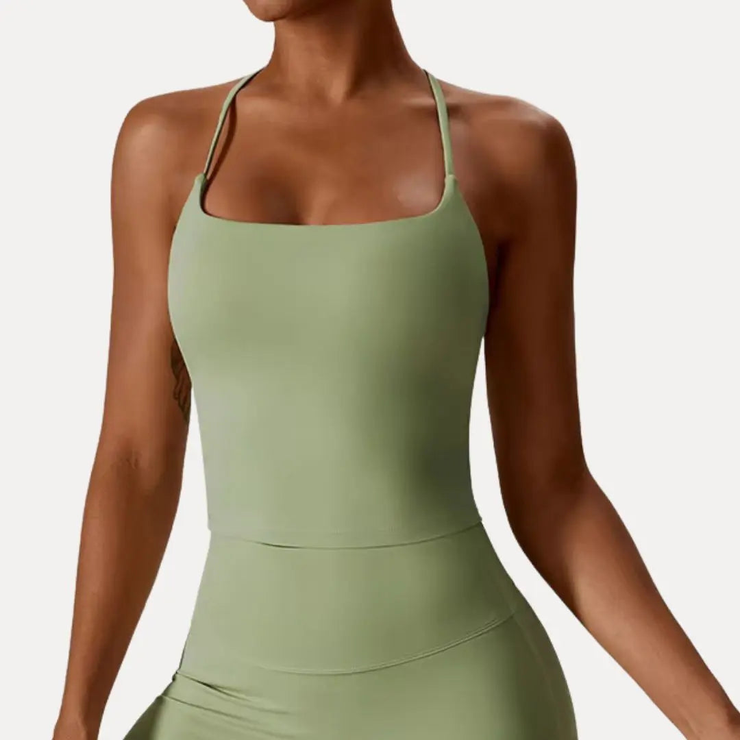 Women's black sleek-fit cross-back tank top with breathable stretchy fabric for yoga and workouts