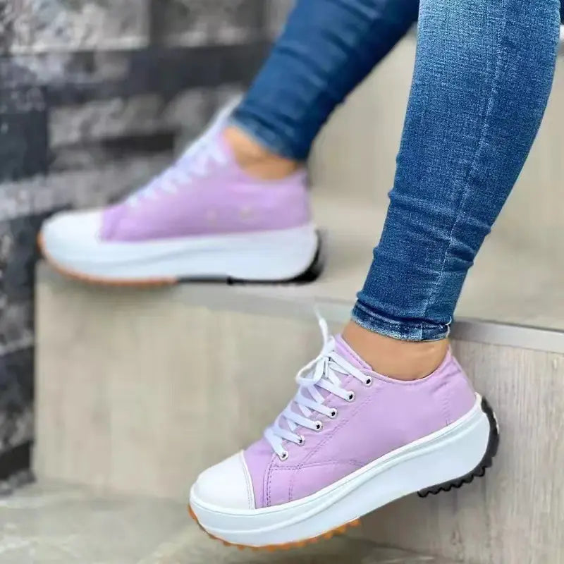 Women's white canvas low-top platform sneakers with thick cushioned sole for all-day comfort