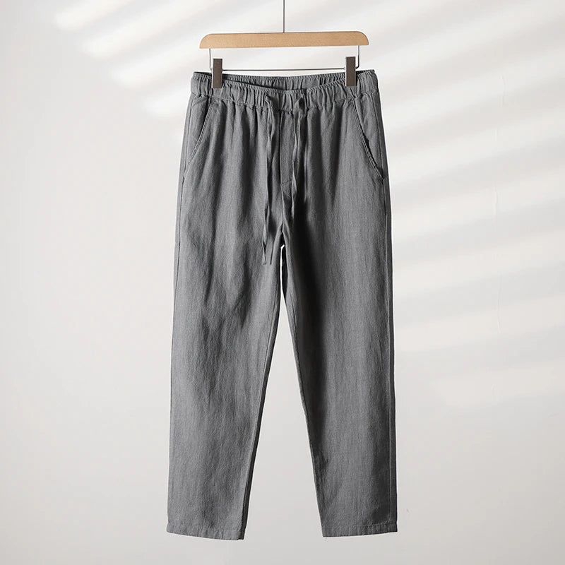 Unisex tapered linen-cotton blend pants in neutral tone with adjustable tie waist for all-day comfort