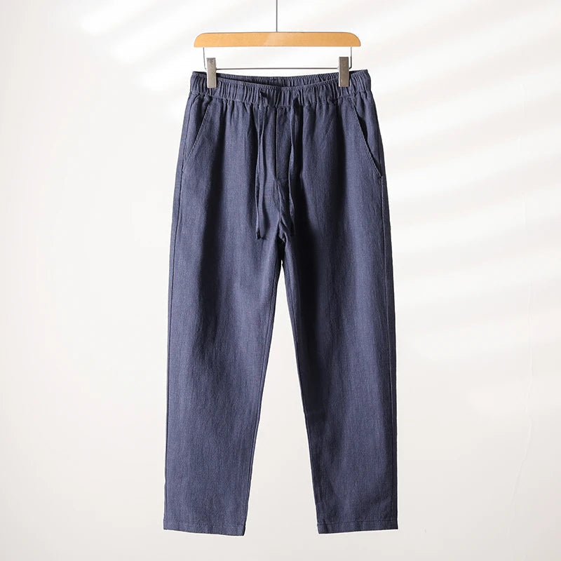 Unisex tapered linen-cotton blend pants in neutral tone with adjustable tie waist for all-day comfort