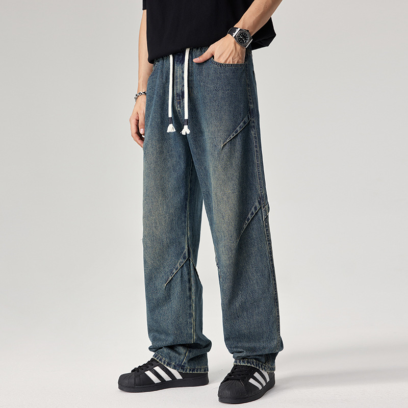 Caulfield relaxed-fit distressed denim joggers in bold washed blue with angular seam detailing
