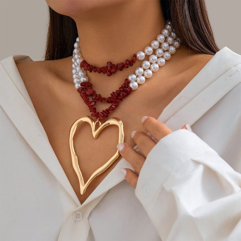 Multi-layer beaded statement necklace with faux pearls, colorful beads, and gold oversized heart pendant