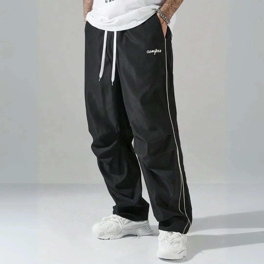 Men's relaxed fit track pants with contrast side piping, adjustable drawstring waist, campus logo