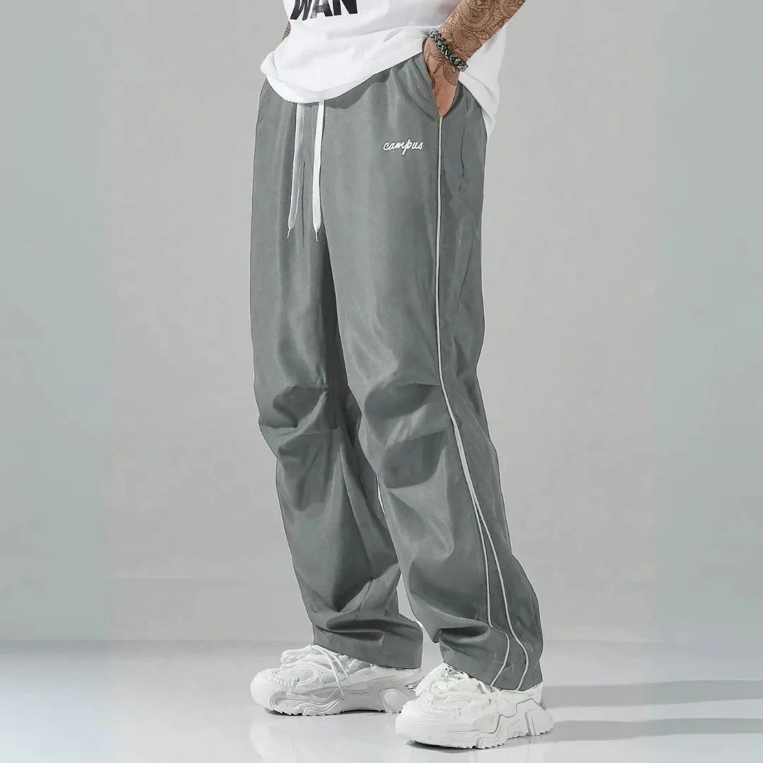 Men's relaxed fit track pants with contrast side piping, adjustable drawstring waist, campus logo