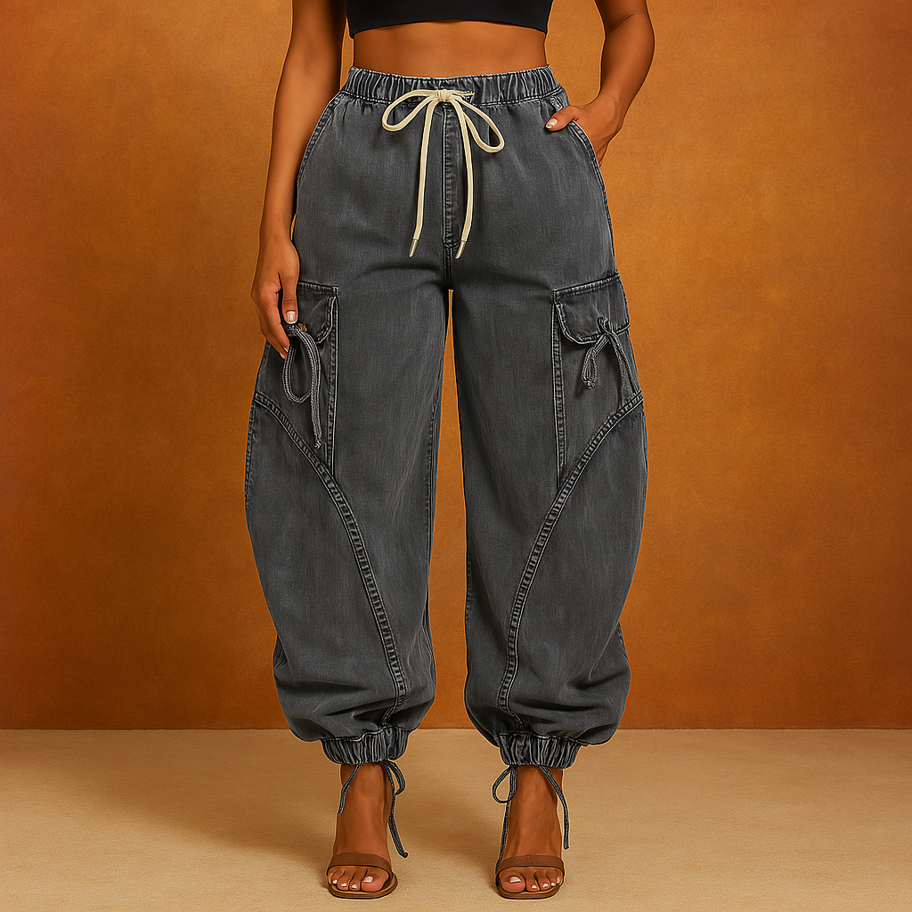 Stonewashed denim jeans with oversized sculpted seams, drawcord cuffs, and relaxed streetwear silhouette