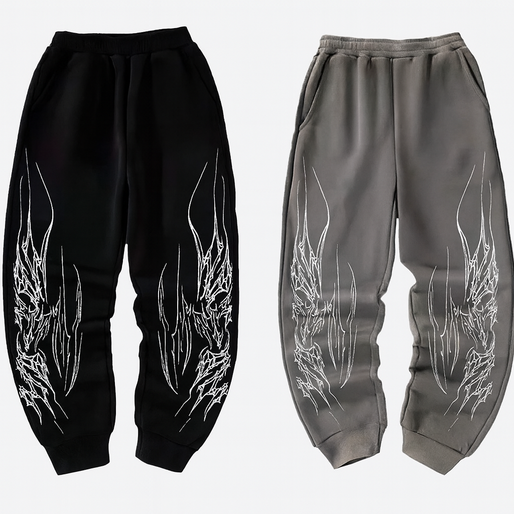 Black relaxed fit sweatpants with white razor wire leg graphics and tapered cuffs for streetwear