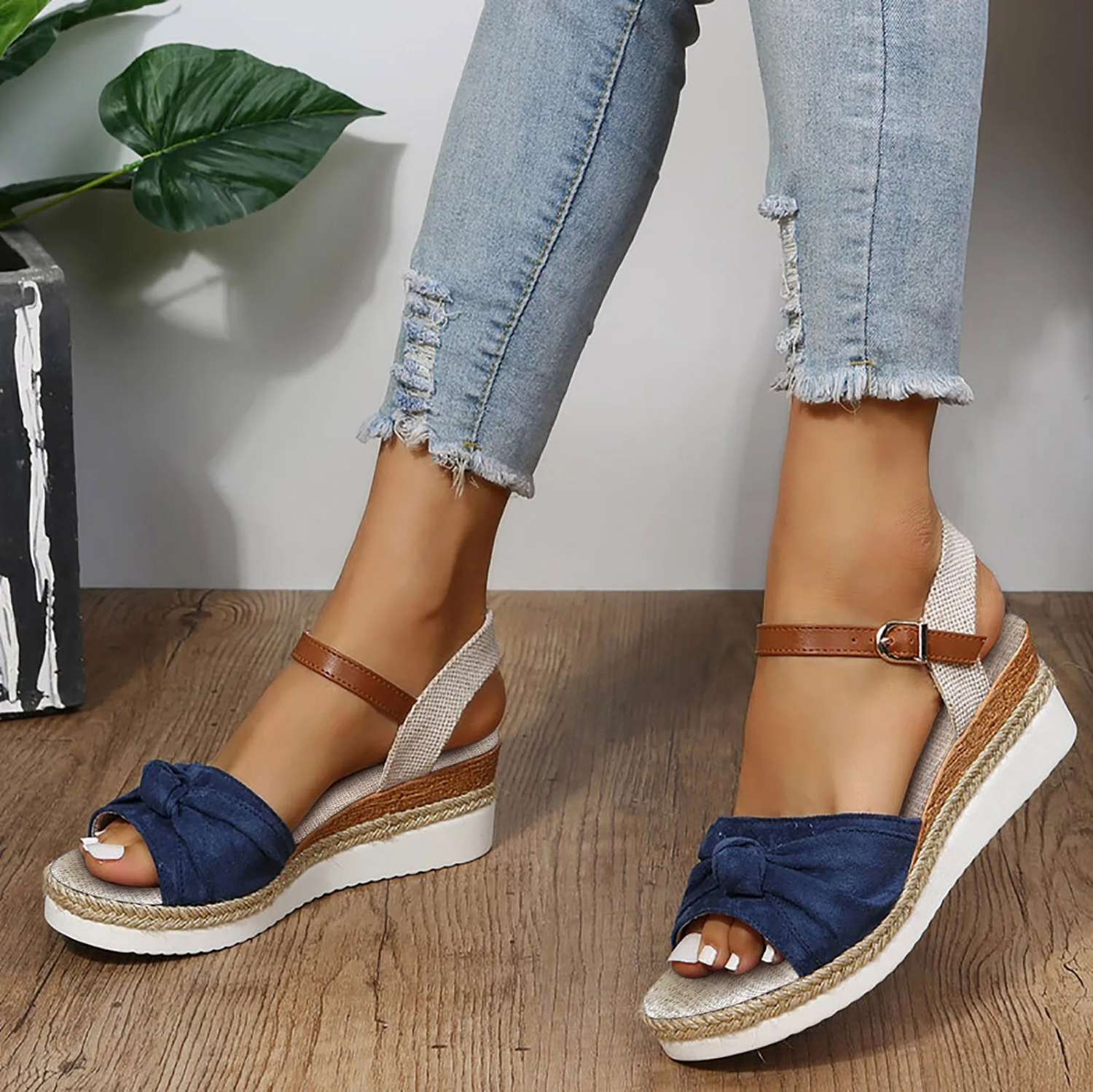 Women's closed toe wedge sandals in neutral tone with chic knot detail and adjustable ankle strap textured sole