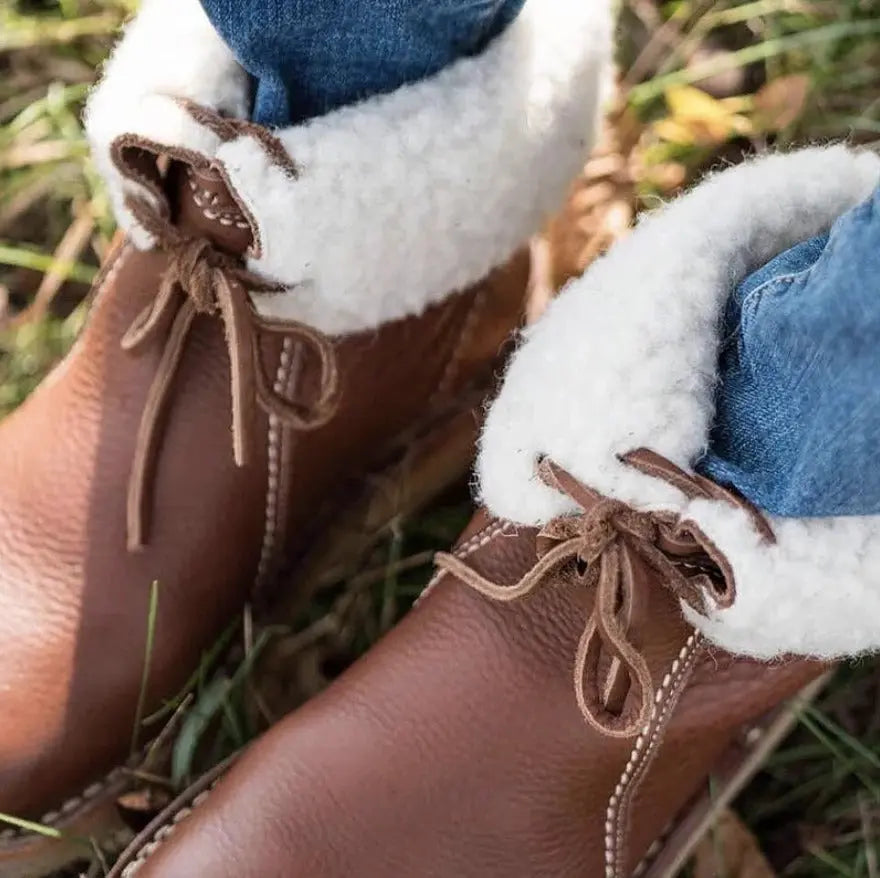 Women's waterproof lace-up winter boots with cozy interior, durable rubber sole, and sleek PU design
