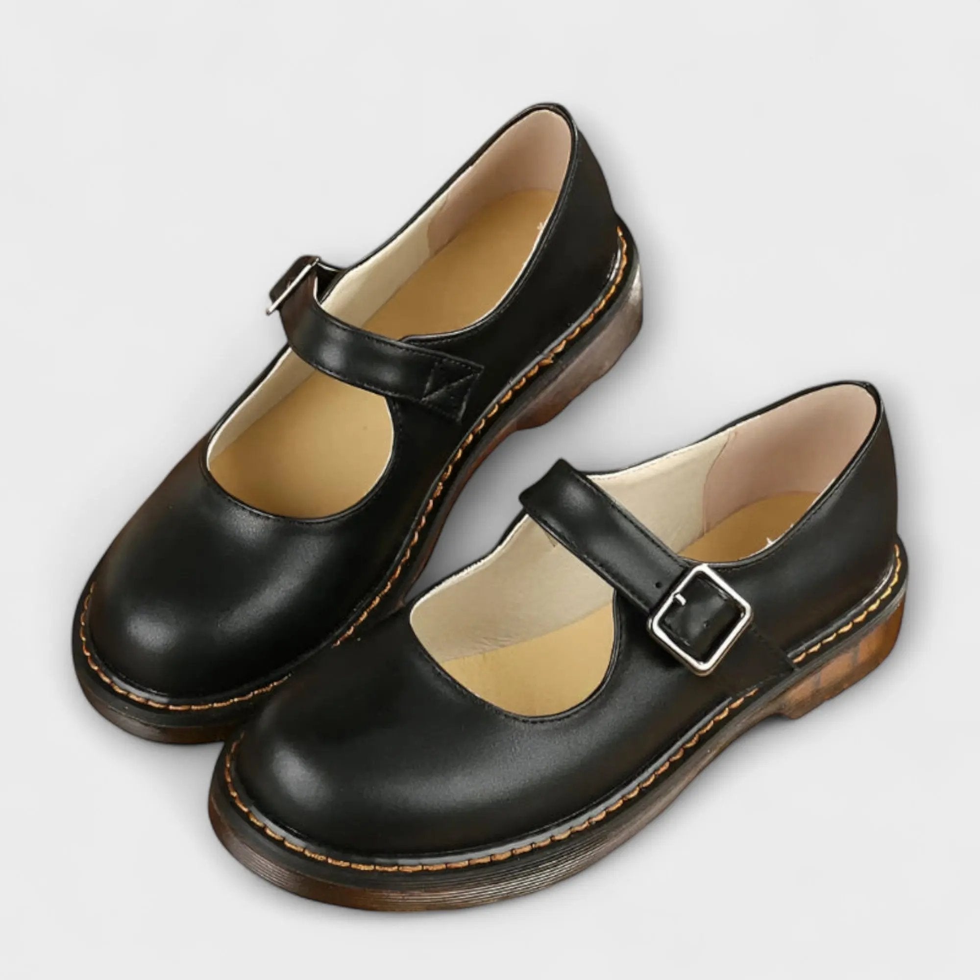 Women's black Mary Jane flats with adjustable buckle strap and cushioned insole for all-day comfort