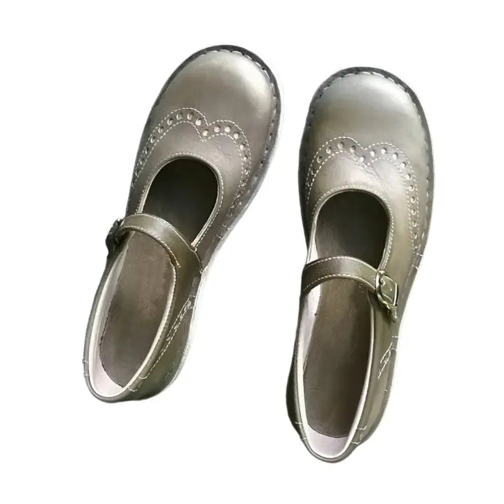Women's black vintage Mary Jane shoes with round toe, brogue detailing, and adjustable buckle strap