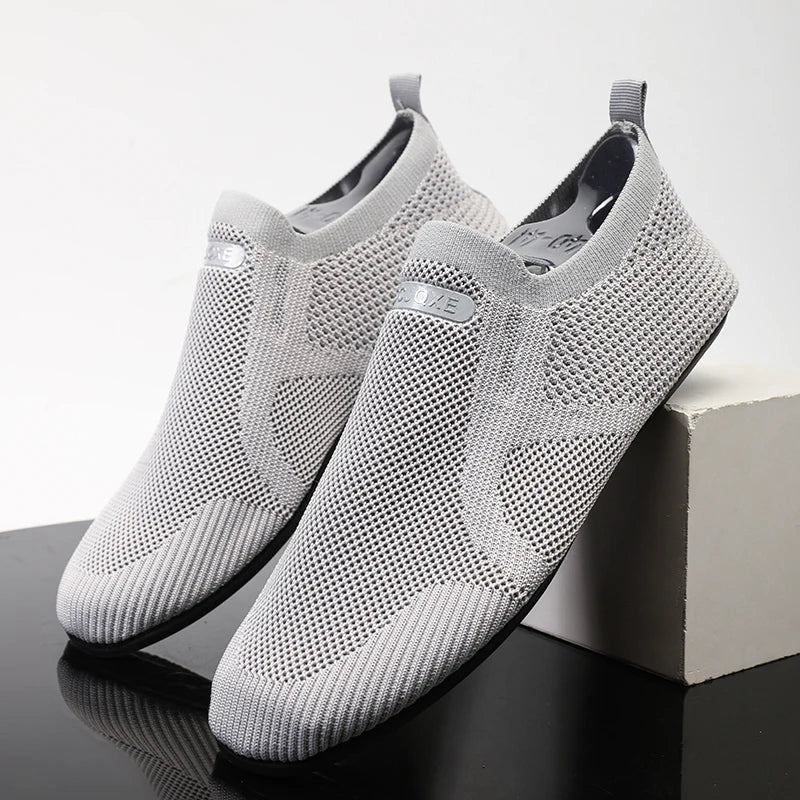 Men's gray mesh slip-on loafer with breathable stretch-knit upper and ultra-light sole