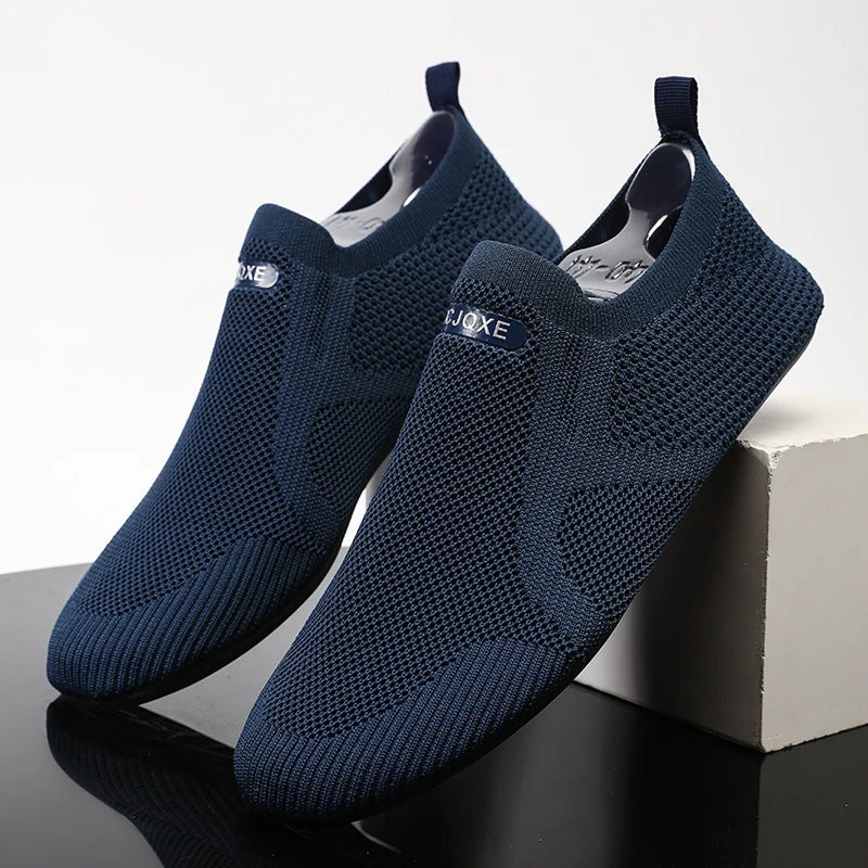 Men's gray mesh slip-on loafer with breathable stretch-knit upper and ultra-light sole