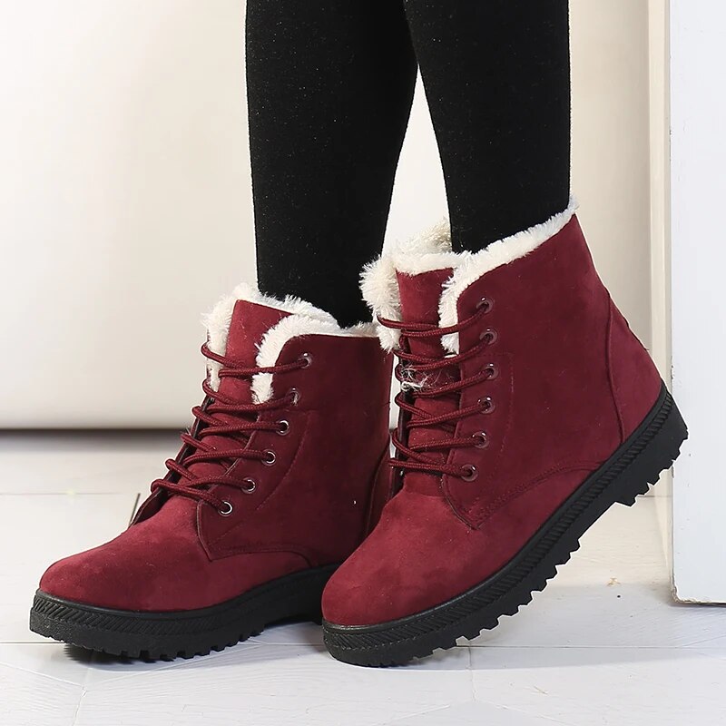 Women's cozy slip-on ankle boots in black with warm fleece lining, water-resistant winter style