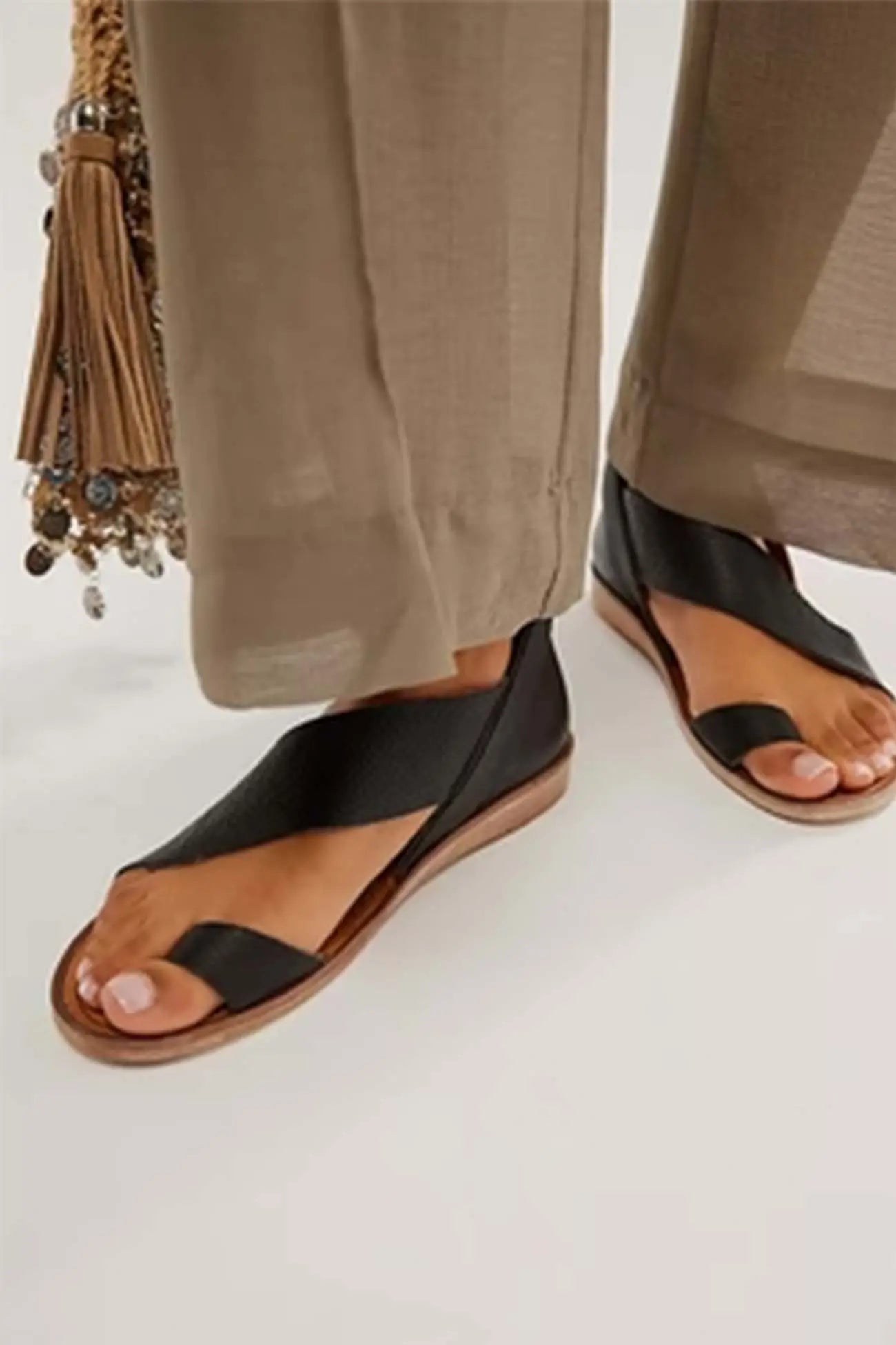 Women beige crisscross flat sandals with textured PU straps and adjustable ankle strap