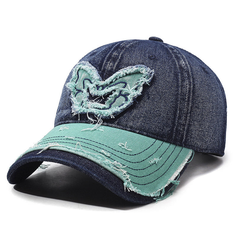 Women's washed denim baseball cap with embroidered butterfly accent, retro wings, curved brim