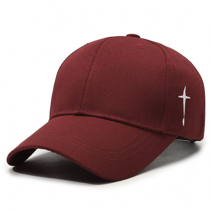 Washed cotton baseball cap with bold cross embroidery, curved brim, adjustable fit, street-style