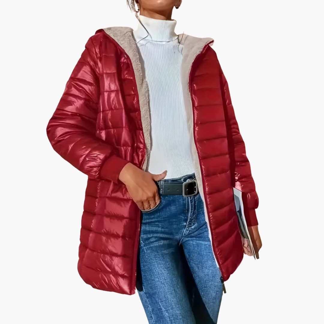 Women's longline quilted hooded coat with front zipper pockets and ribbed cuffs streamlined silhouette