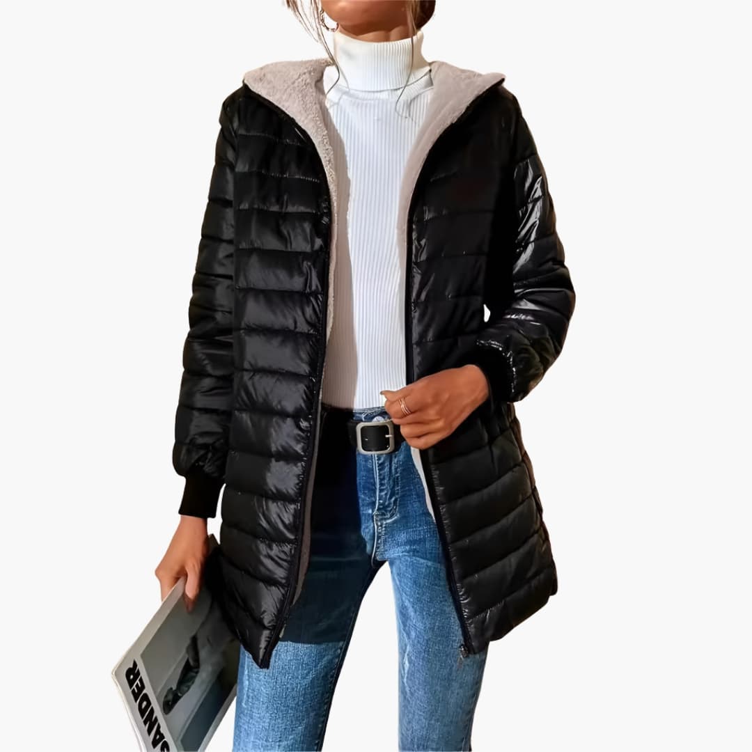 Women's longline quilted hooded coat with front zipper pockets and ribbed cuffs streamlined silhouette
