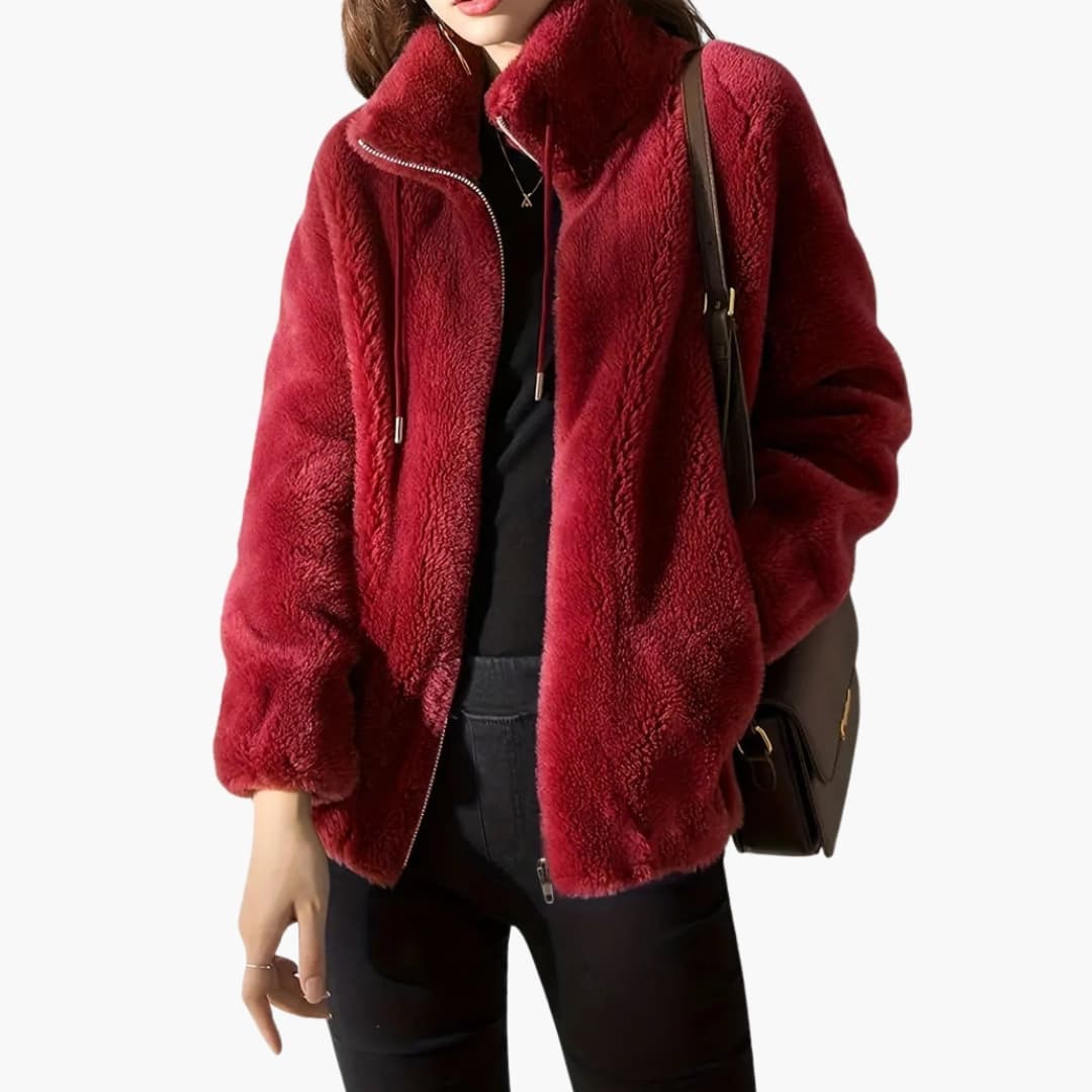 Women's beige teddy coat with high collar, front zipper, adjustable hem, and cozy textured finish